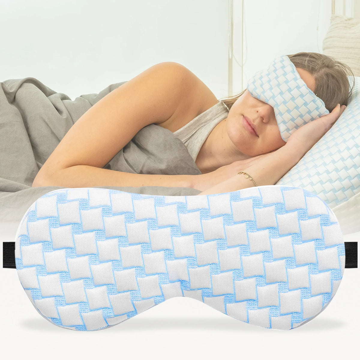 A woman sleeping with a blue Ella Weighted sleep mask, perfect for a good night's rest and relaxation.