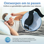 A woman lies relaxed in bed with a pillow and pillowcase, while wearing the Ella Weighted sleep mask.